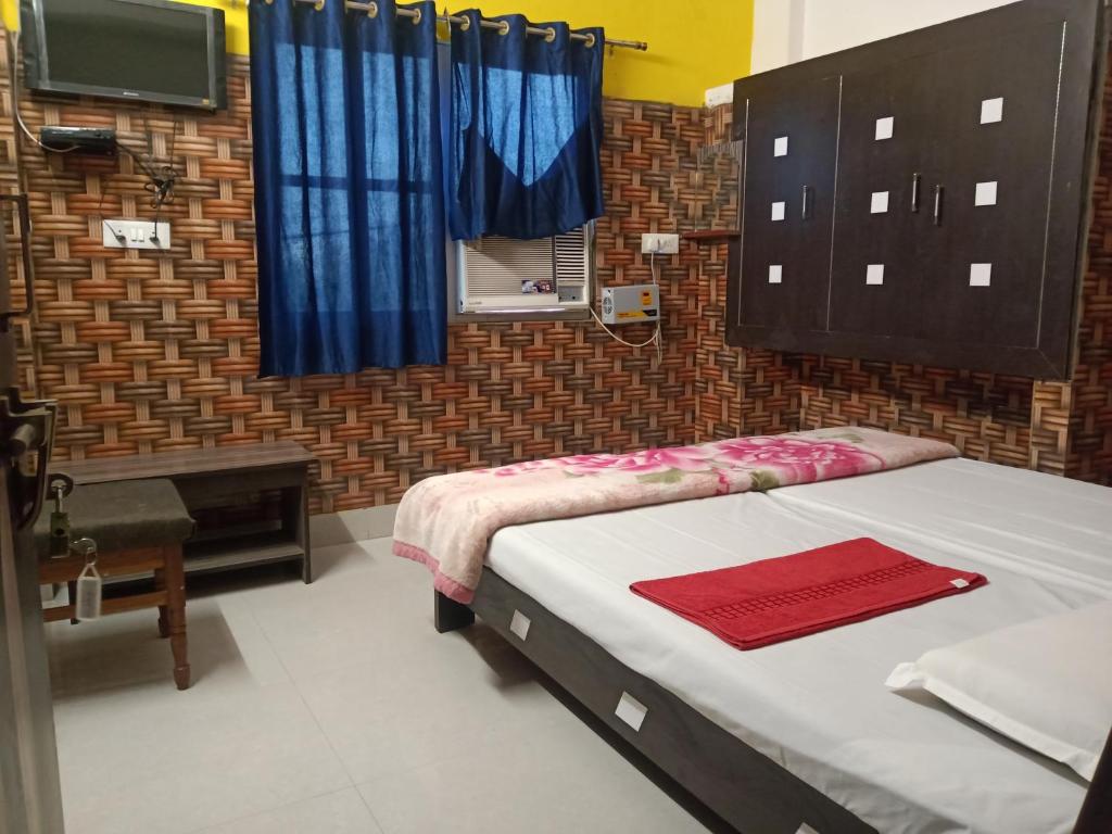 a bedroom with two beds and a tv in it at Hotel Vinayak Vihar, Sasaram in Ara
