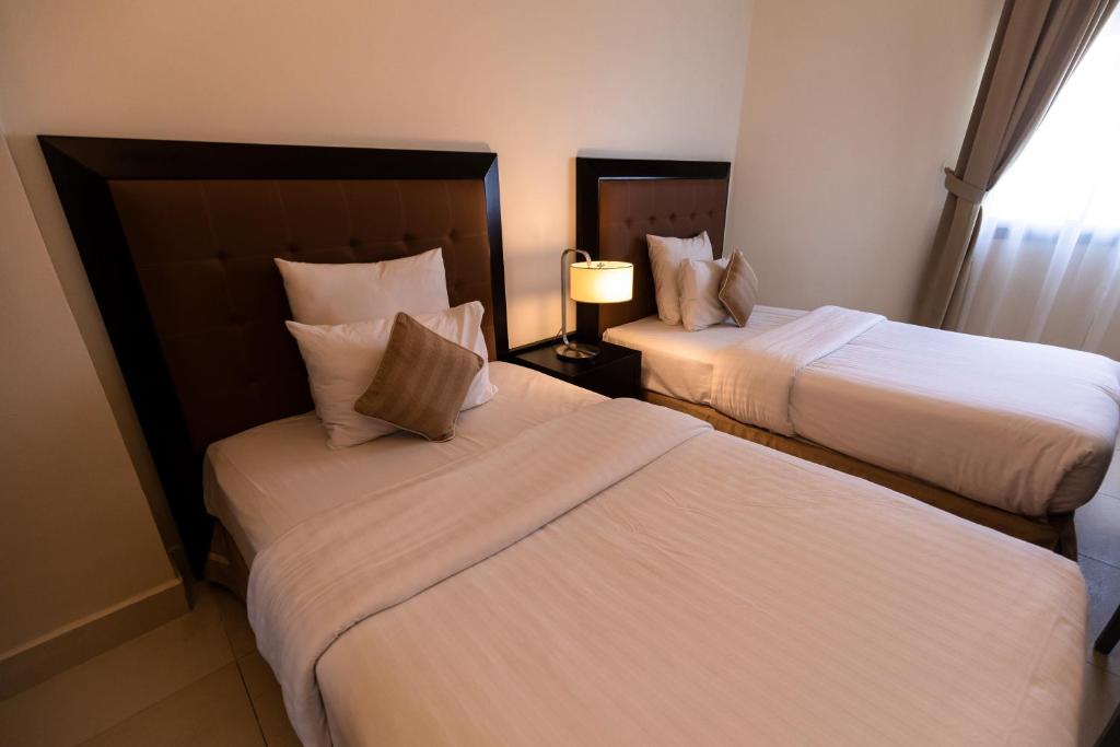 Ένα ή περισσότερα κρεβάτια σε δωμάτιο στο Imperial Suites Hotel