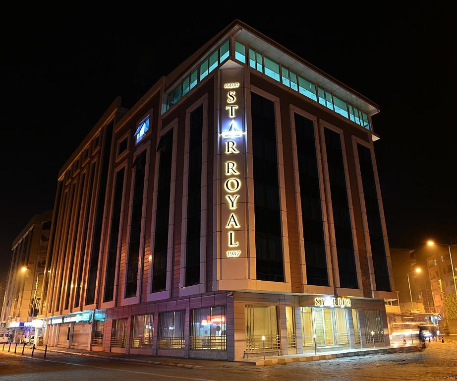 a large building with a sign on it at night at Hotel Star Royal in Igdır