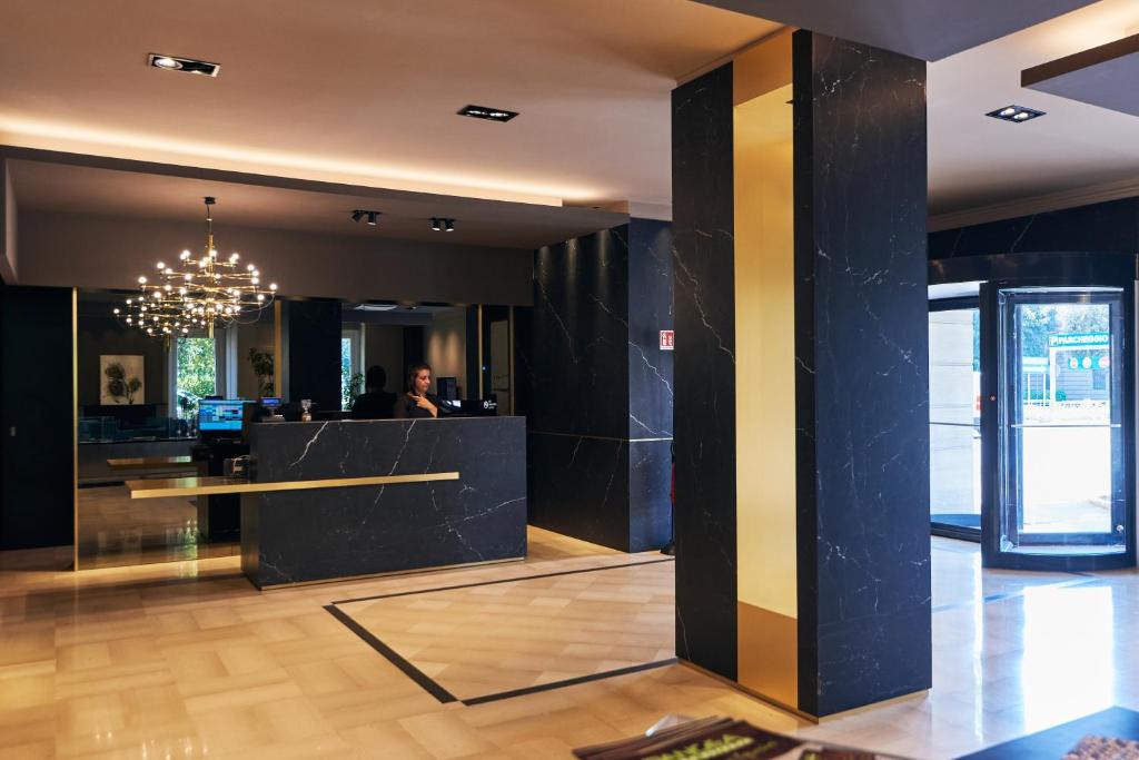 a lobby with a counter and a person in the background at Hotel Poledrini in Foligno