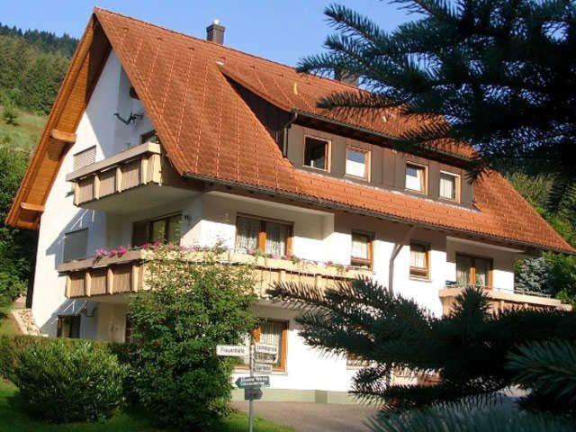 a house with an orange roof on top of it at Ferienwohnung Herbert Best in Baiersbronn