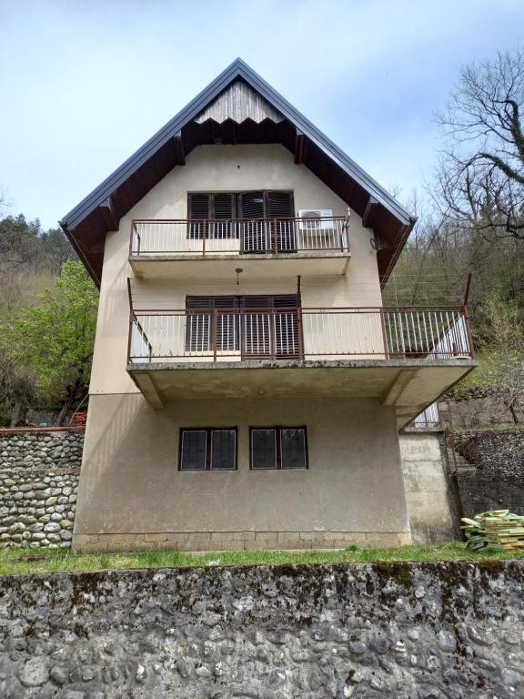 a building with a balcony on the side of it at Adventure Land in Jablanica
