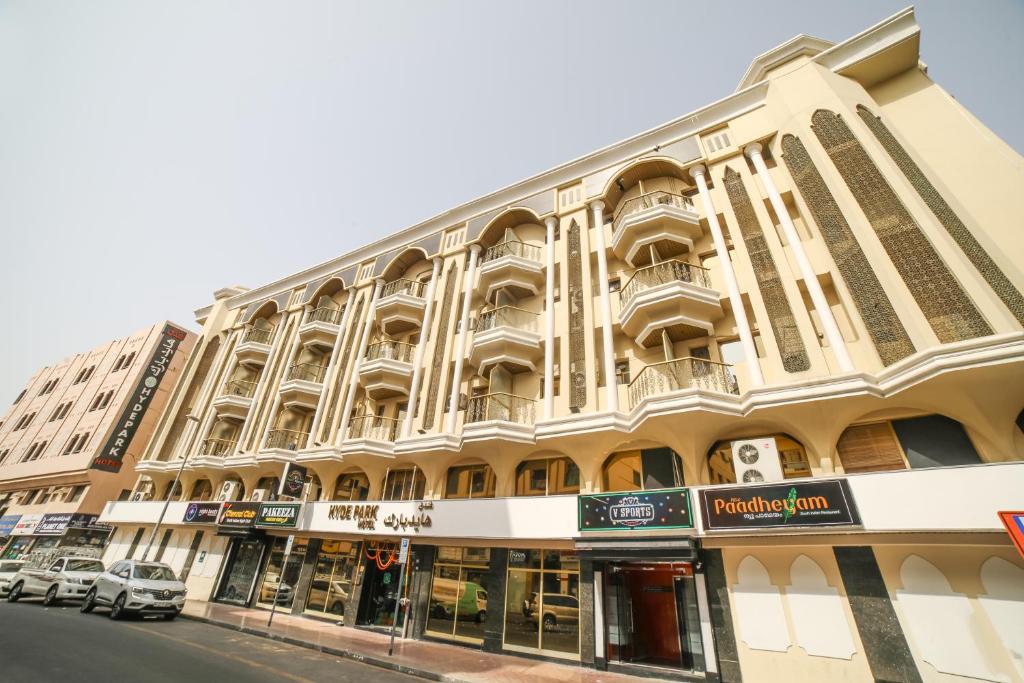 a large building on the corner of a street at Hyde Park Hotel in Dubai