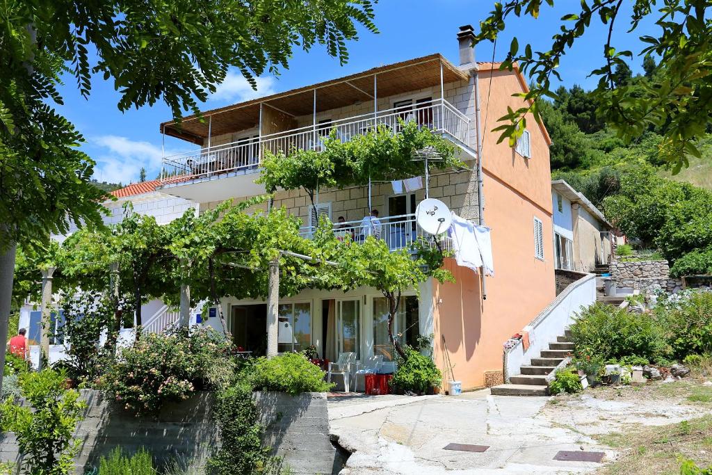 a house with a balcony on the side of it at Apartments with a parking space Zuljana, Peljesac - 254 in Žuljana