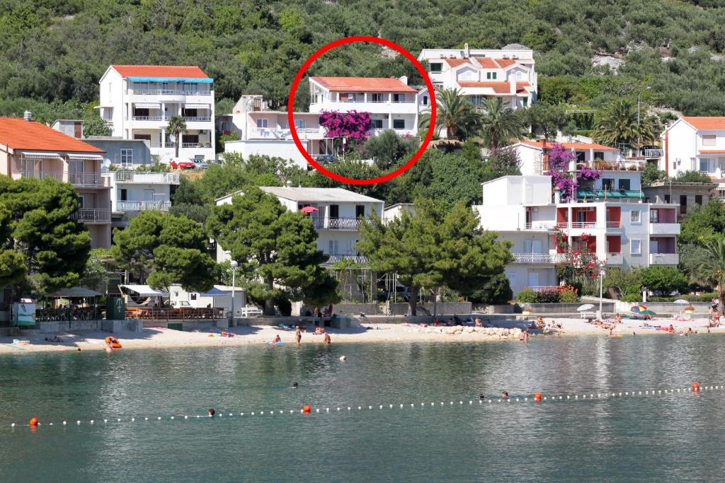a group of people on a beach near the water at Apartment Igrane 310e in Igrane