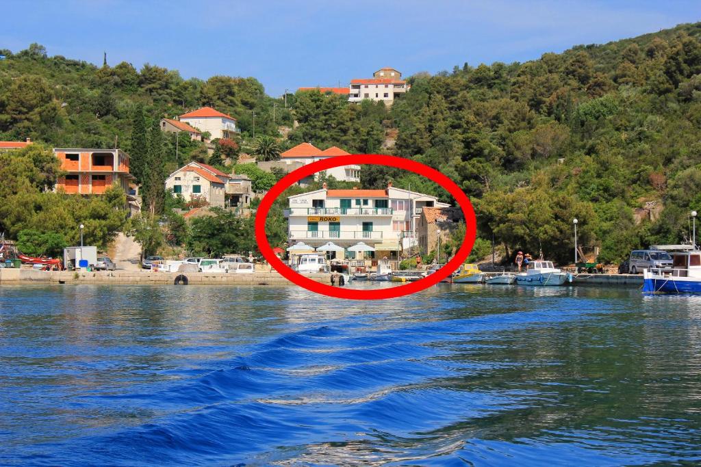 a house in the middle of a body of water at Apartments and rooms by the sea Zaglav, Dugi otok - 393 in Sali