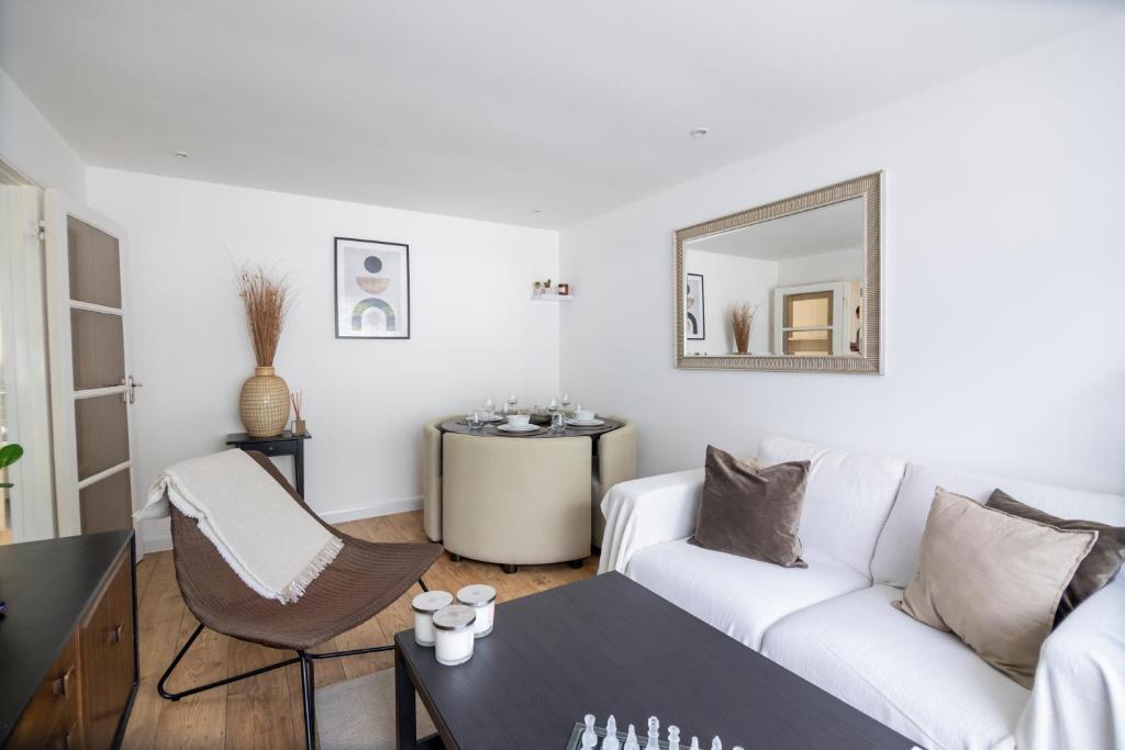 sala de estar con sofá blanco y espejo en Gorgeous Modern Apartment near Redhill Station inc Private Garden & Parking, en Redhill