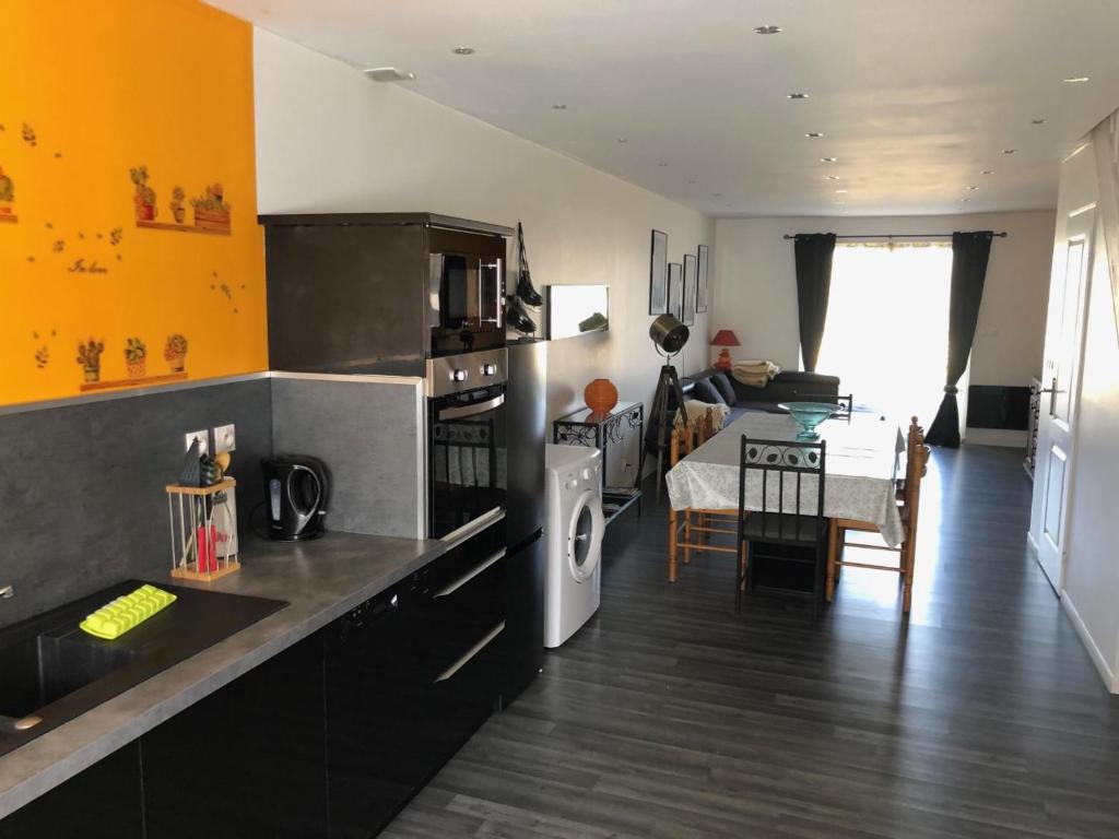 a kitchen with a counter and a dining room at Les villas d'Hannogne in Hannogne-Saint-Martin