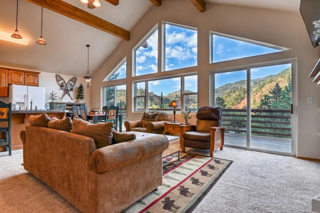 a living room with a couch and a large window at Mountain Vistas - Lake Views at Buffalo Sunrise in Green Mountain Falls