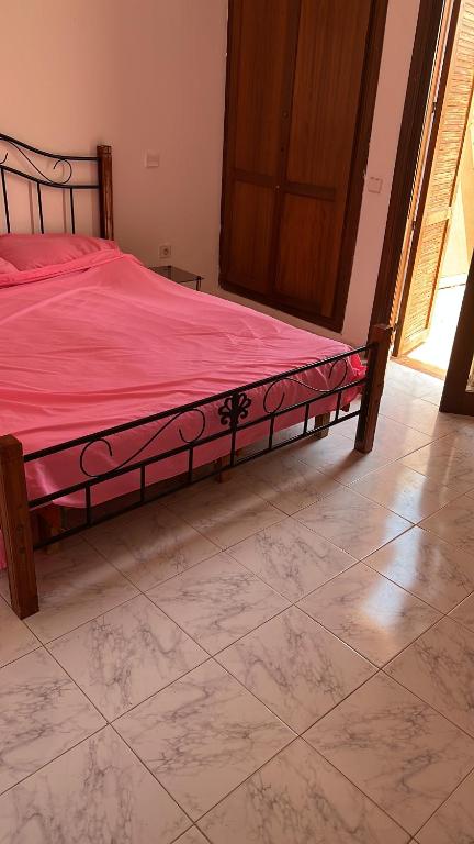 a bedroom with a bed with a red comforter at Magnifique villa duplex au bord de la piscine in Tetouan