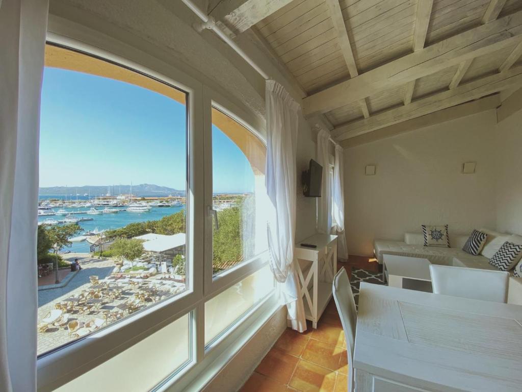 Habitación con ventana grande con vistas a la playa. en San Marco LT, en Porto Rotondo