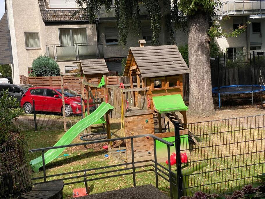a wooden play set with a slide and a playground at stylische Maisonettewohnung Stadionnähe,Wald,Westfalenhalle in Dortmund