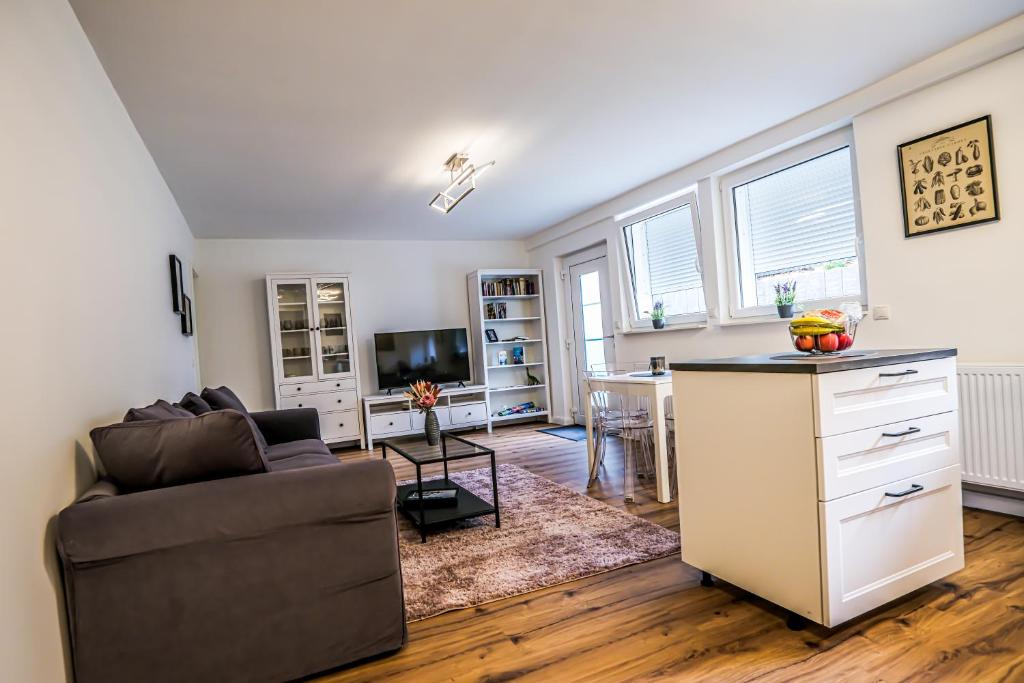 a living room with a couch and a table at Exklusive Neubau Wohnung im Luftkurort Buchholz in Buchholz in der Nordheide