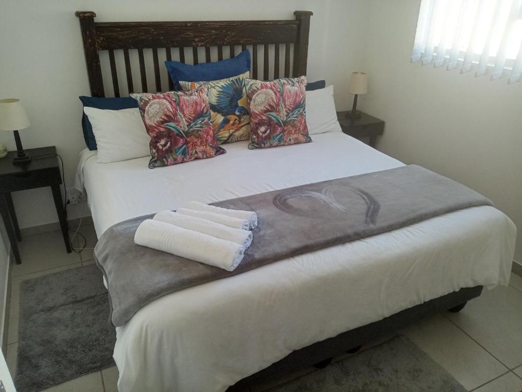 a bedroom with a bed with towels on it at Covenant Place in Cape Town