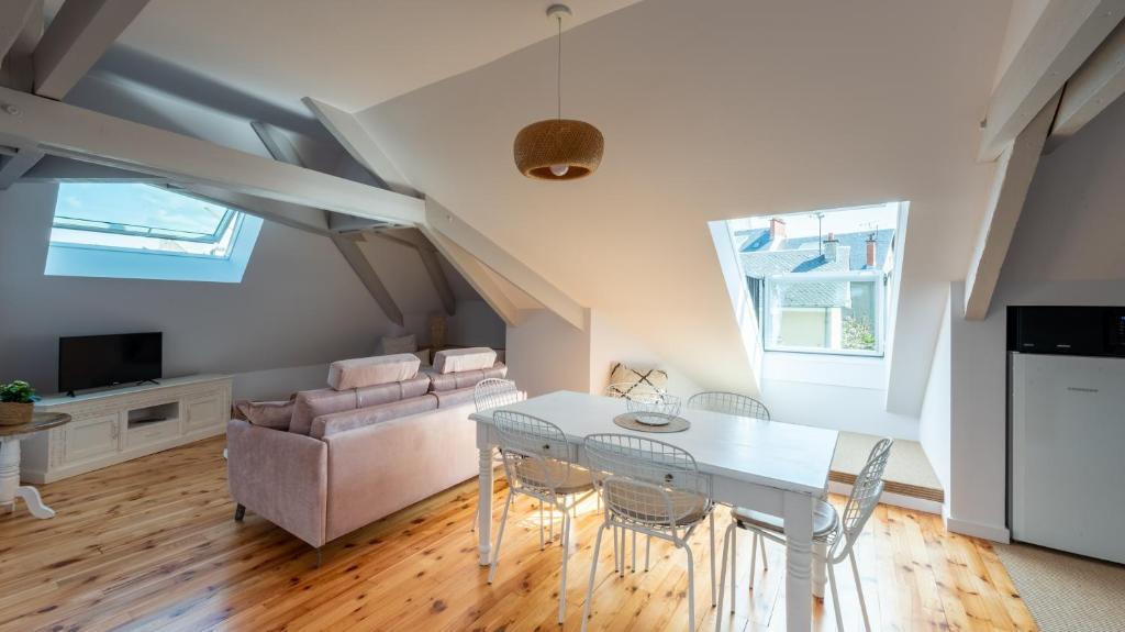 a living room with a white table and chairs at Le Grenier Cosy, T2 classé meublé de tourisme in Rodez