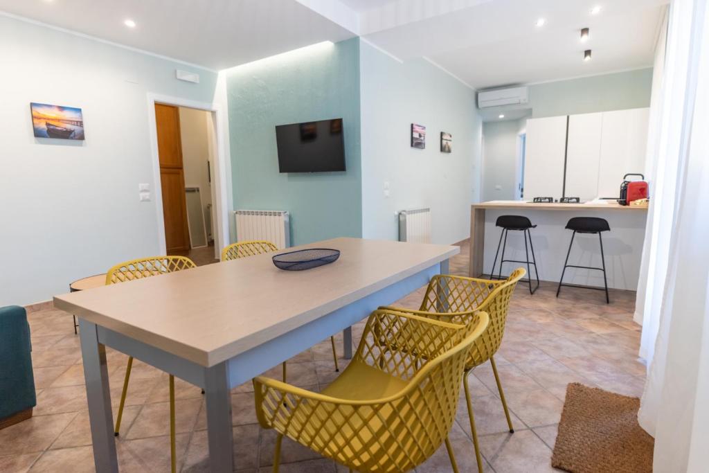 a dining room with a table and chairs at Teo House Beach in Taormina