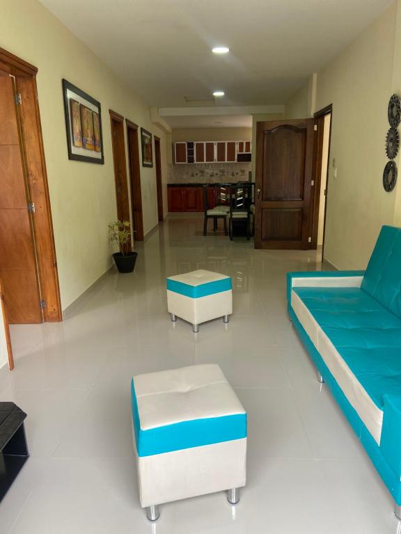 a living room with a bed and a couch and tables at Mi Balconcito in Salento