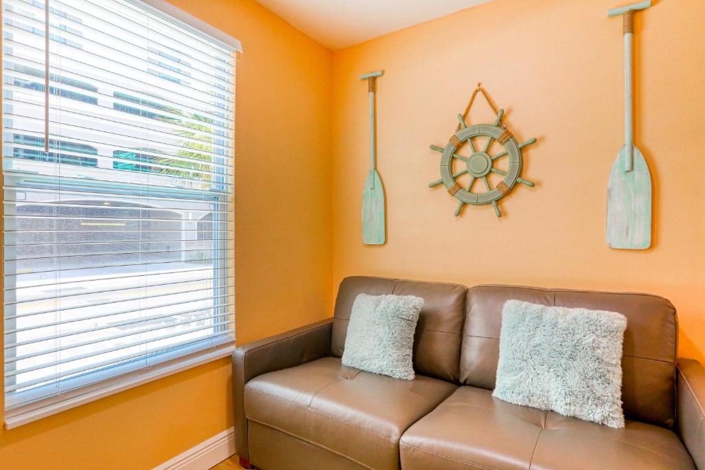 a living room with a brown couch and a window at East Shore Paradise #448 in Clearwater Beach