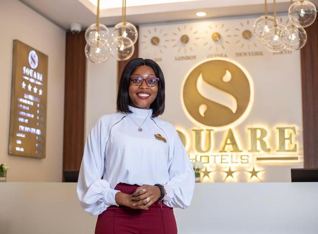 a woman is standing in front of a stage at Souaré Premium Hôtel in Conakry