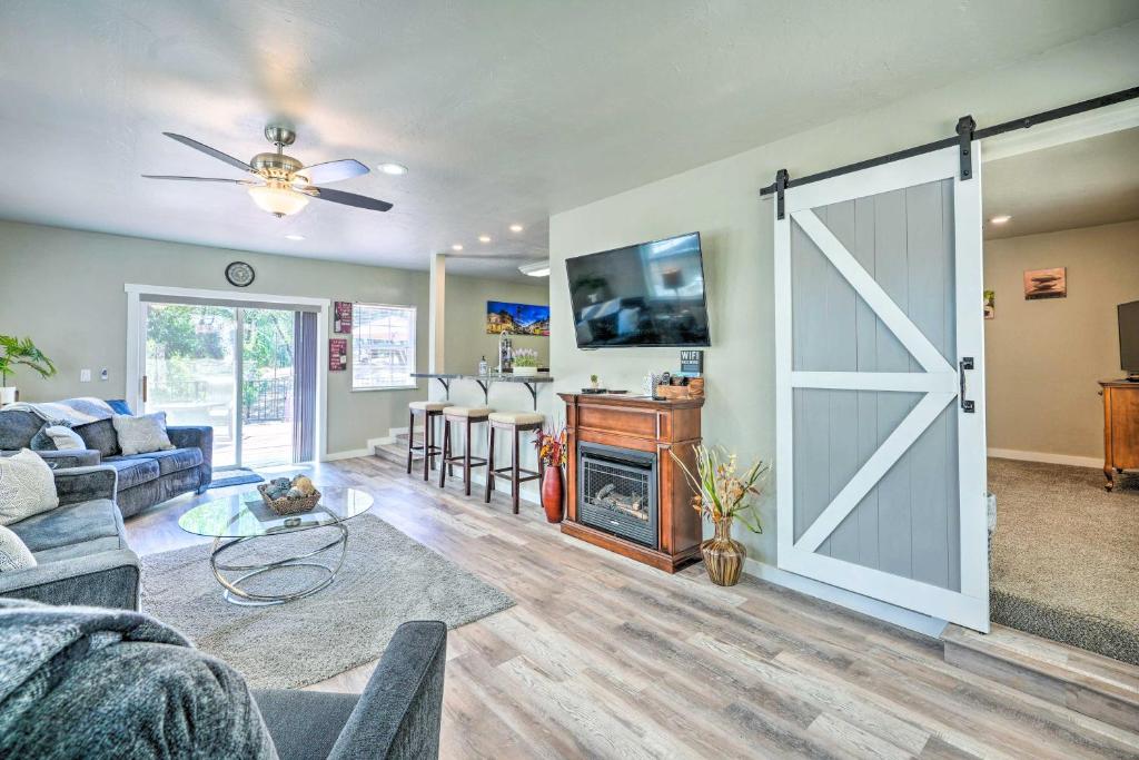 a living room with a sliding barn door and a kitchen at Pleasant Wine Country Escape with Fire Table! in Fair Play