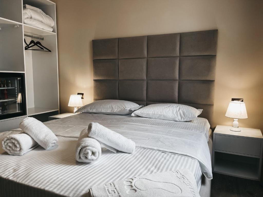 a bedroom with two beds with towels on them at Amansar Boutique Hotel in Tirana