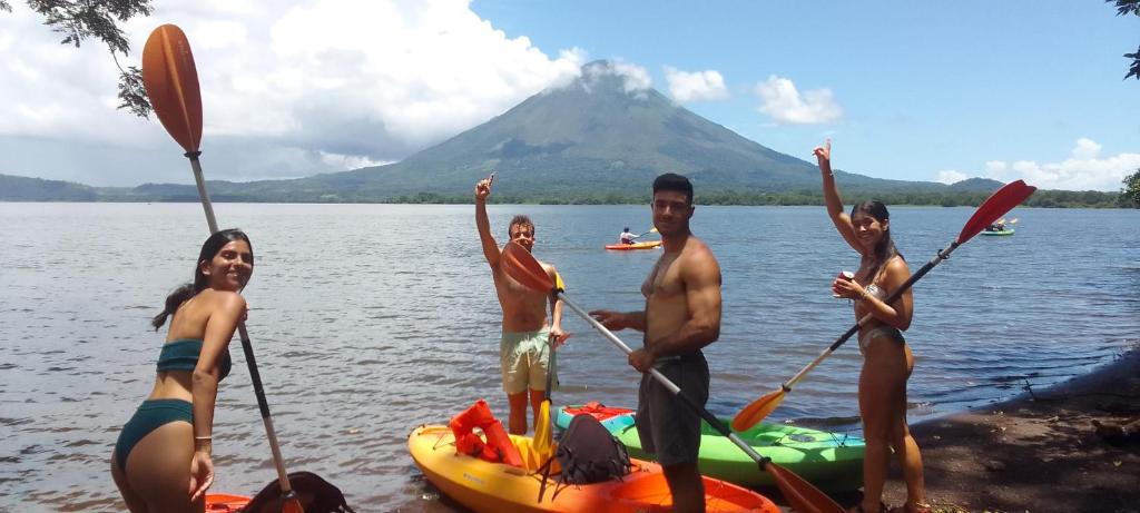 a group of people on a lake with a mountain in the background at Hostal Bullshark in Cuatro Esquinas