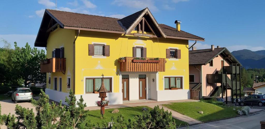 a yellow house with a brown roof at Casa Gialla in Lavarone