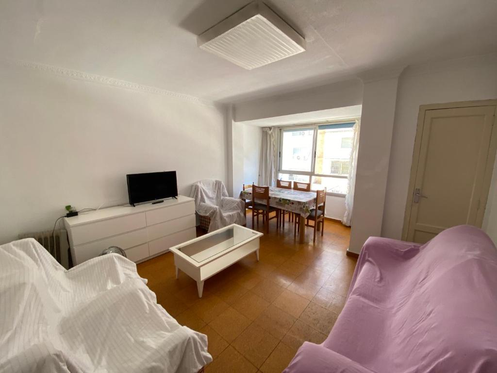 a living room with two beds and a table at piso para jovenes familia cerca playa y centro . BLASCO IBANEZ A in Valencia