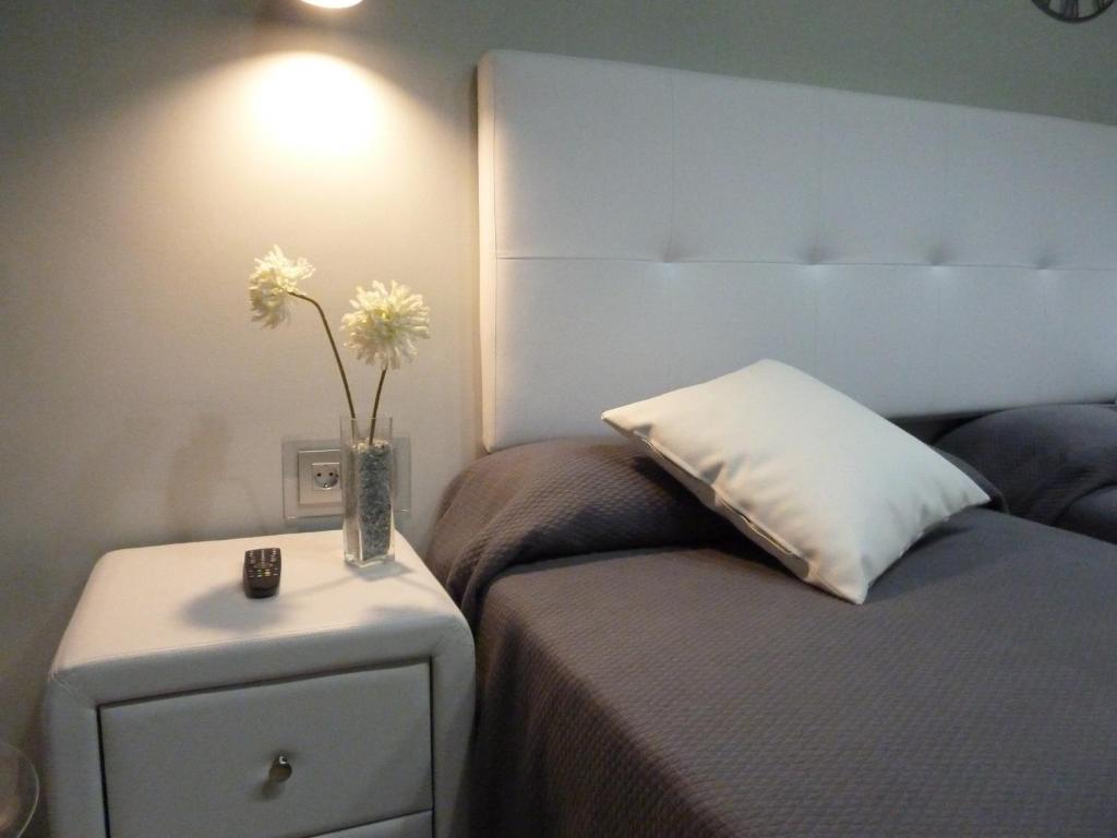 Postel nebo postele na pokoji v ubytování Hostal Lauria