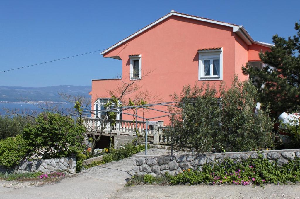 a house on a hill with a stone wall at Apartments with a parking space Vrbnik, Krk - 429 in Vrbnik
