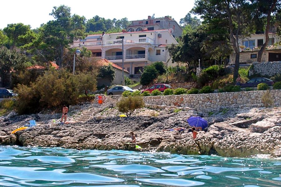 a group of people on the shore of a body of water at Apartments by the sea Prigradica, Korcula - 544 in Blato
