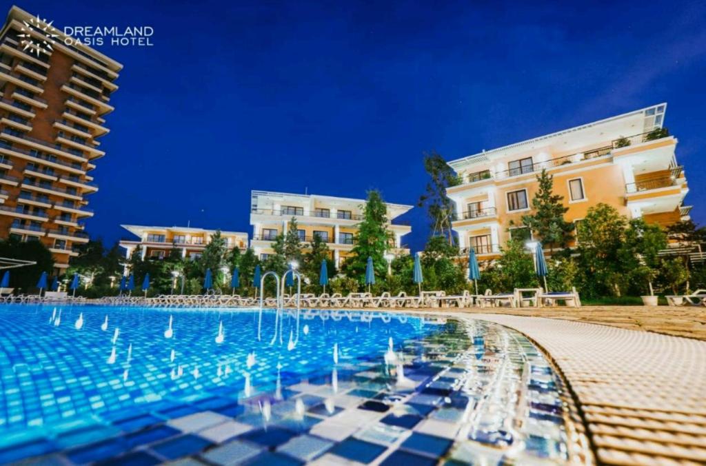 a large swimming pool in front of some buildings at Chakvi Dreamland Oasis hotel in Chakvi