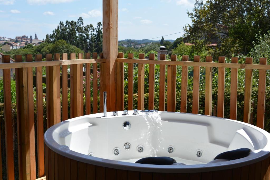 a bath tub sitting on top of a deck at Cabañas Compostela - Cabaña La Catedral con bañera de hidromasaje in Santiago de Compostela