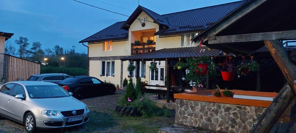 a white car parked in front of a house at La Ionicã Rozavlea MM in Rozavlea