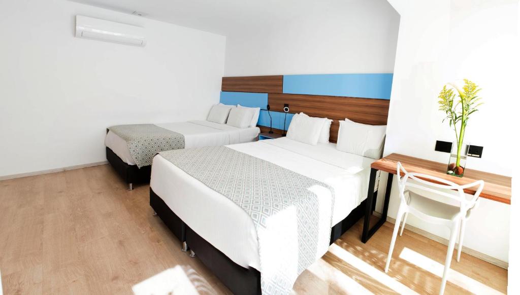 Postel nebo postele na pokoji v ubytování Foresta Hotel