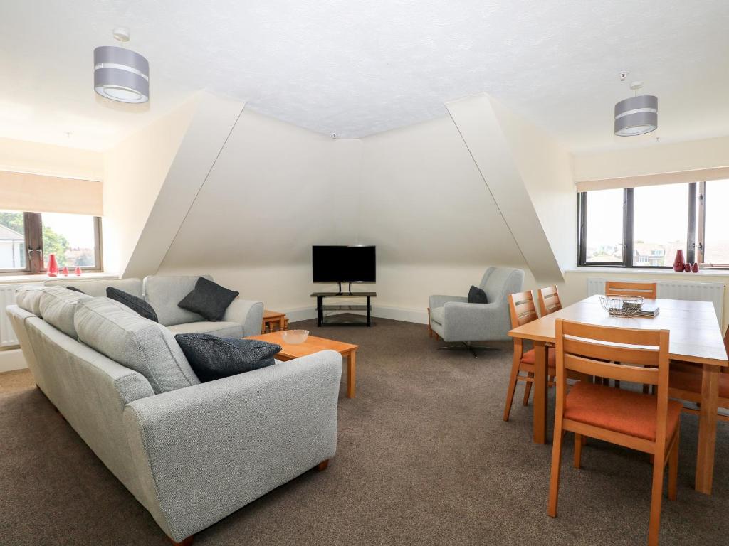 a living room with a couch and a table at Flat 35 - Marine Court in Littlehampton