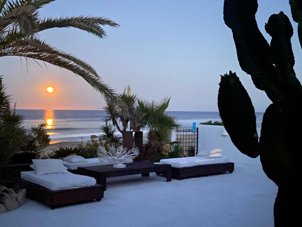 a patio with a view of the ocean at sunset at Villa Playa Mojacar in Mojácar