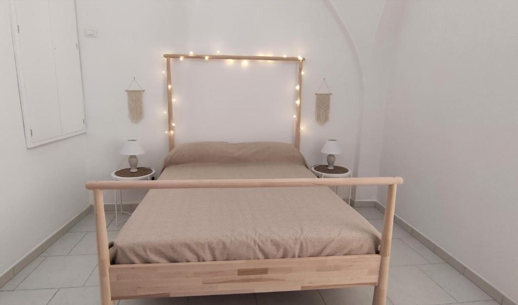 a bed with lights on it in a room at Appartamenti Boho Chic in Sannicandro di Bari