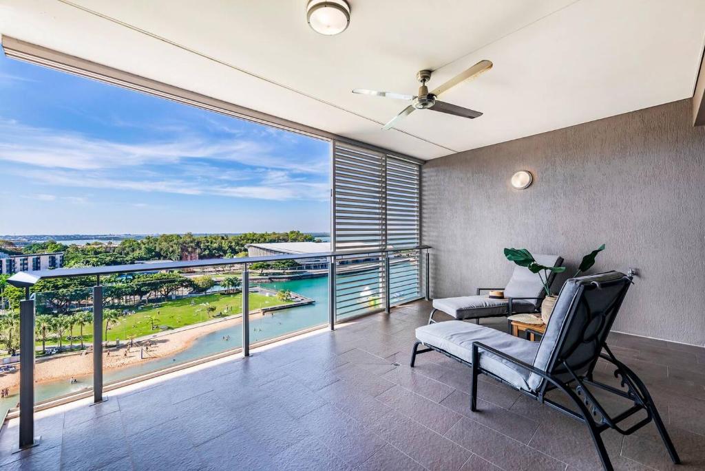a living room with a balcony with a view of the beach at Top of Timor Sea A Luxury Waterfront Penthouse in Darwin
