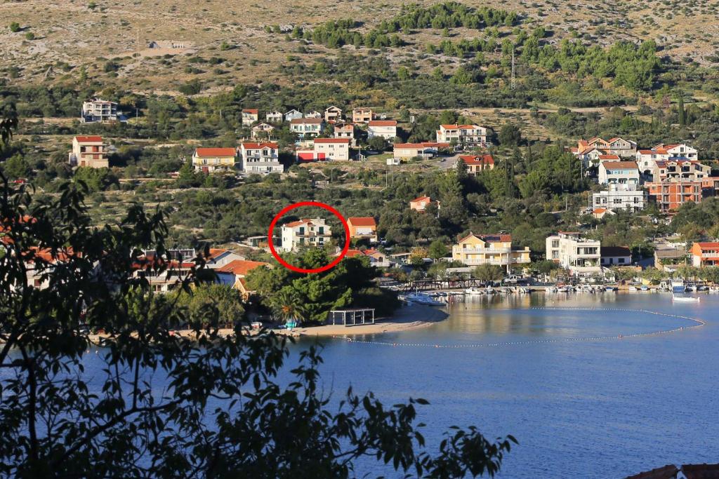 a small island in the middle of a body of water at Apartments with a parking space Grebastica, Sibenik - 4866 in Grebaštica