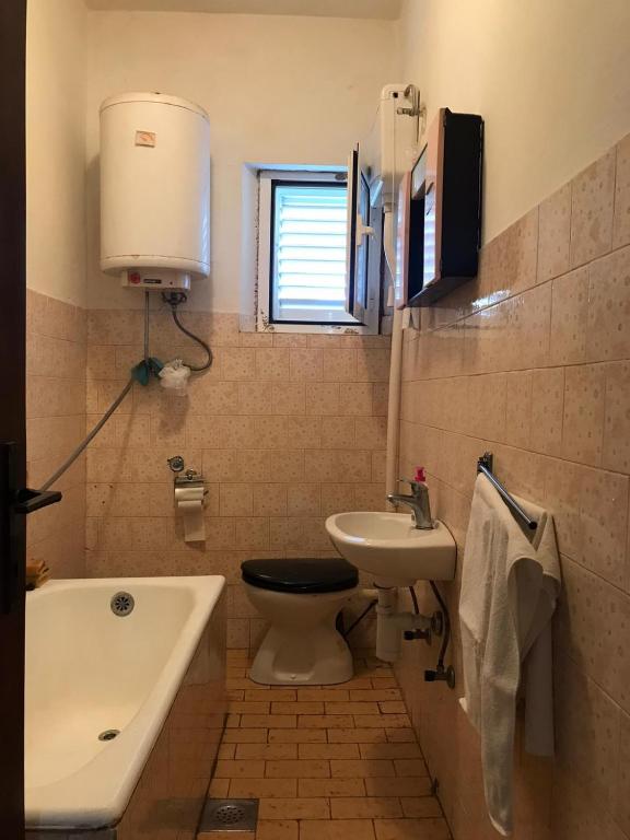 a small bathroom with a toilet and a sink at Seaside secluded apartments Cove Blaca, Mljet - 615 in Saplunara