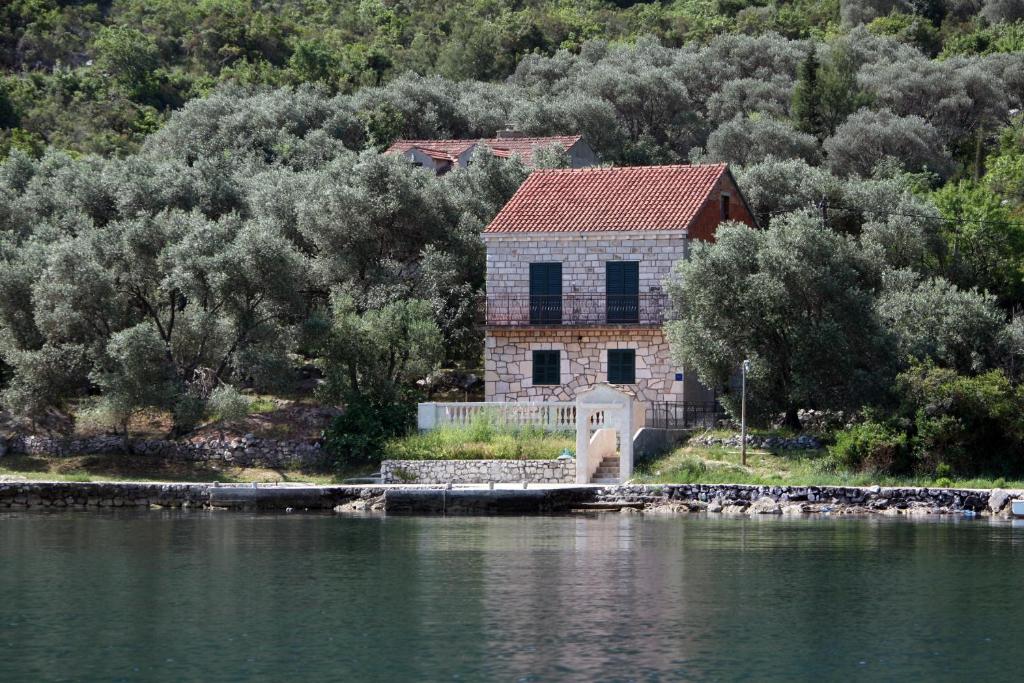 a house on the shore of a body of water at Apartments by the sea Prozurska Luka, Mljet - 619 in Prožura