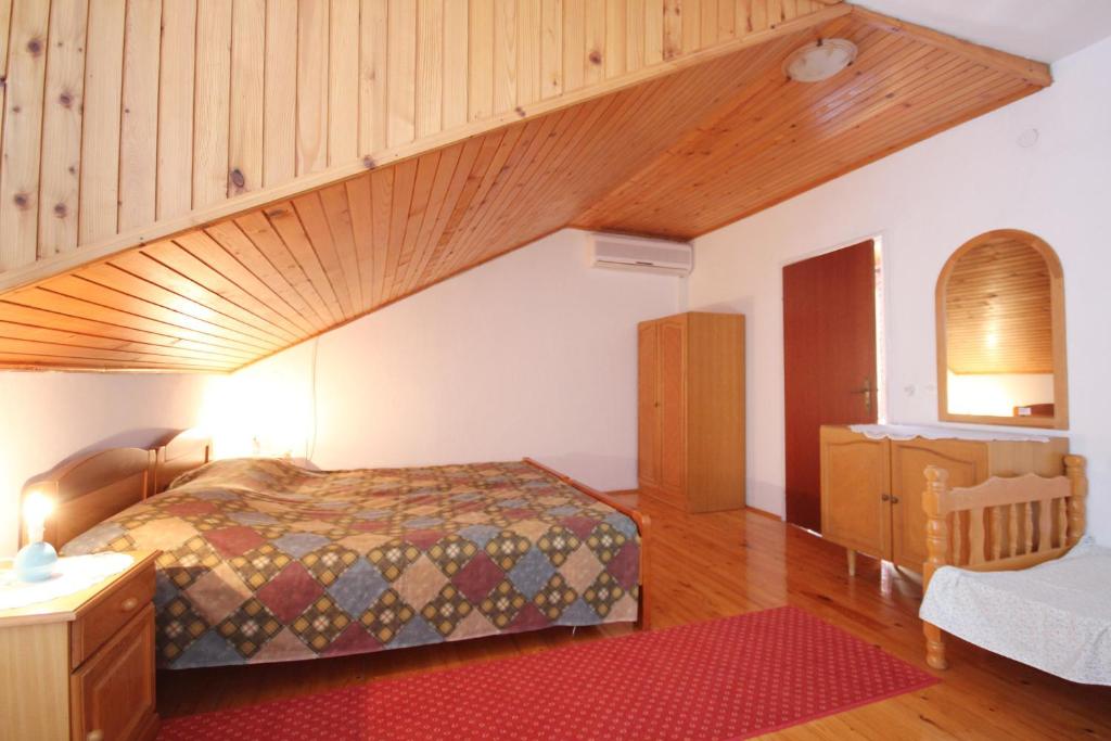 a bedroom with a bed and a wooden ceiling at Apartments by the sea Viganj, Peljesac - 633 in Viganj