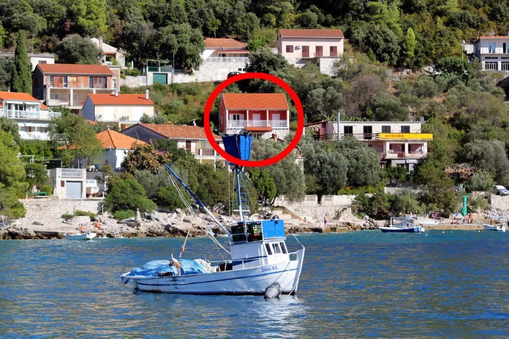 łódź w wodzie z czerwonym krągiem na niej w obiekcie Apartments by the sea Brna, Korcula - 574 w mieście Smokvica
