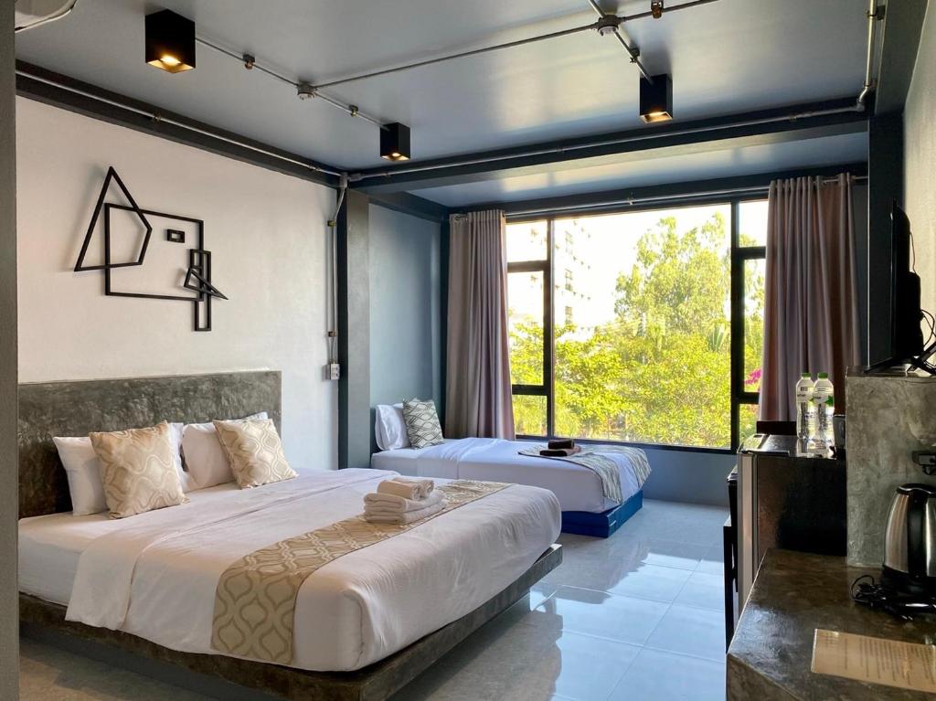 Postel nebo postele na pokoji v ubytování Midtown Sukhothai