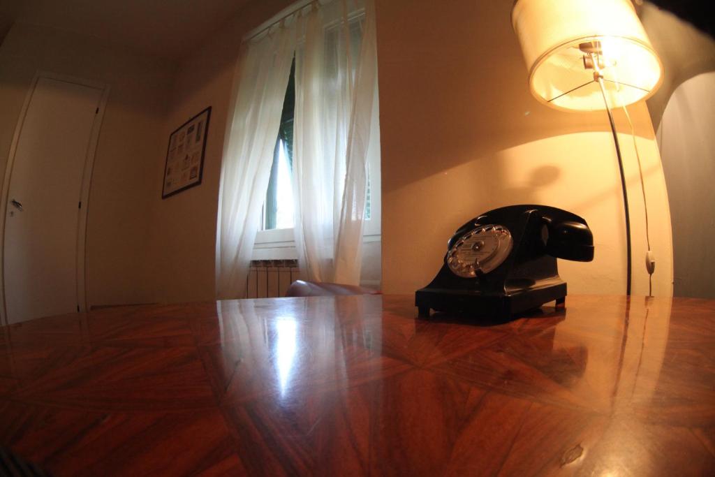 a telephone sitting on a wooden floor in a room at BBQ Lodge in Camogli