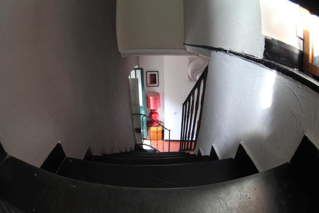 a spiral staircase in a building with a person in the background at BBQ Lodge in Camogli