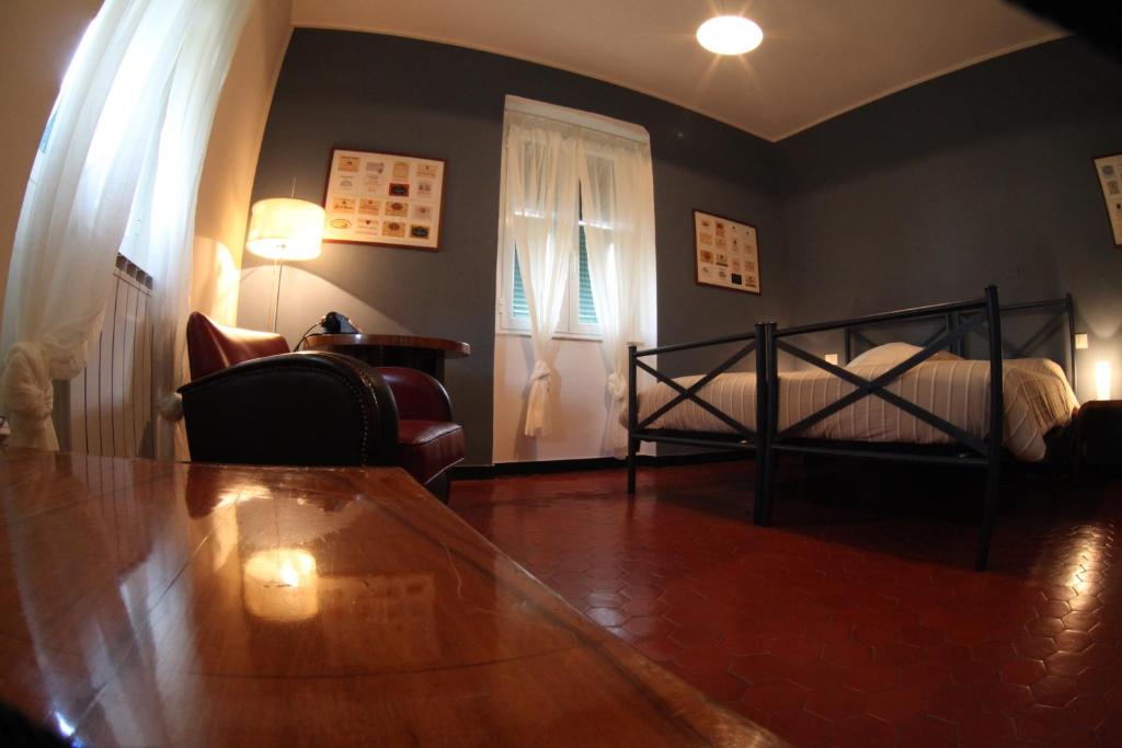 a bedroom with a bed and a table and chairs at BBQ Lodge in Camogli