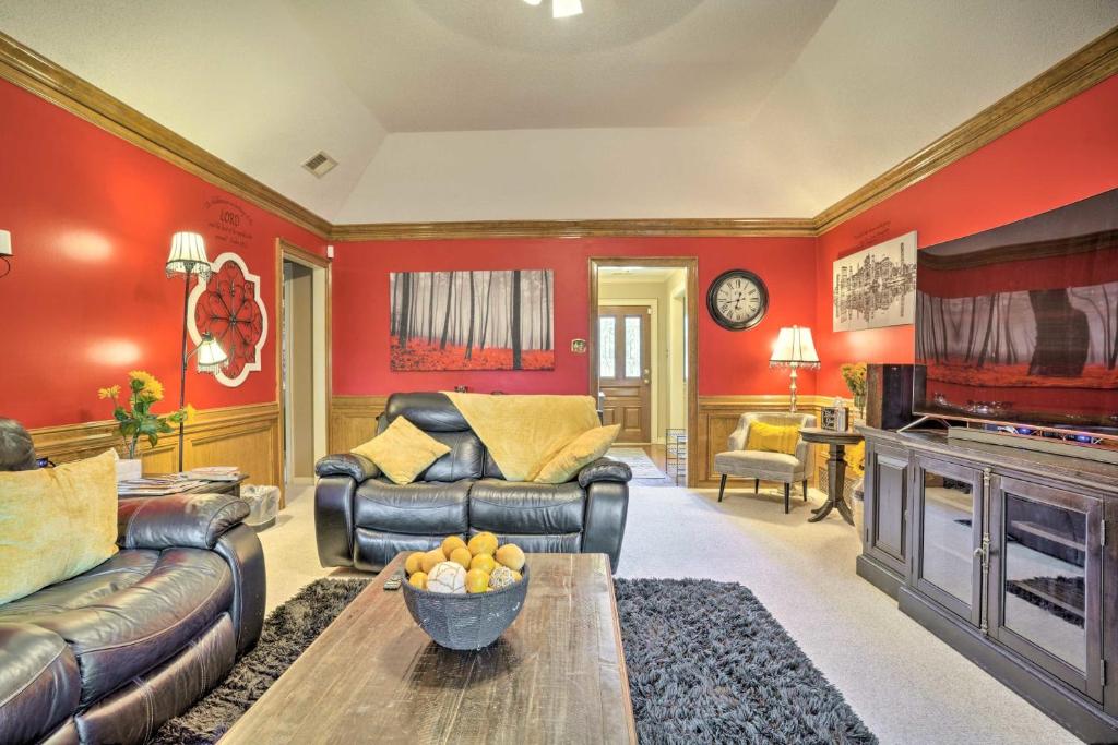 a living room with red walls and leather furniture at Comfortable and Pleasant 4 Bedroom Home in Memphis