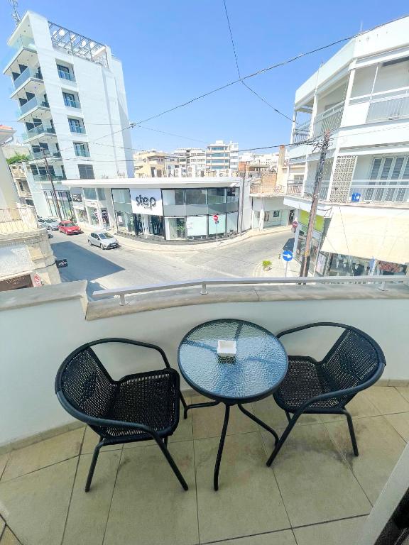 a table and two chairs sitting on a balcony at High Speed Holiday Apartment in Larnaca